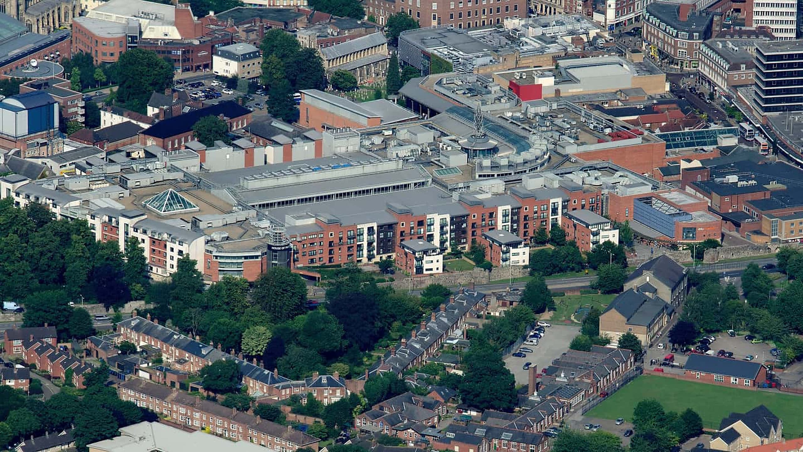 Aerial view of commercial rooftops showing membrane condition, rooftop equipment, and parapets.