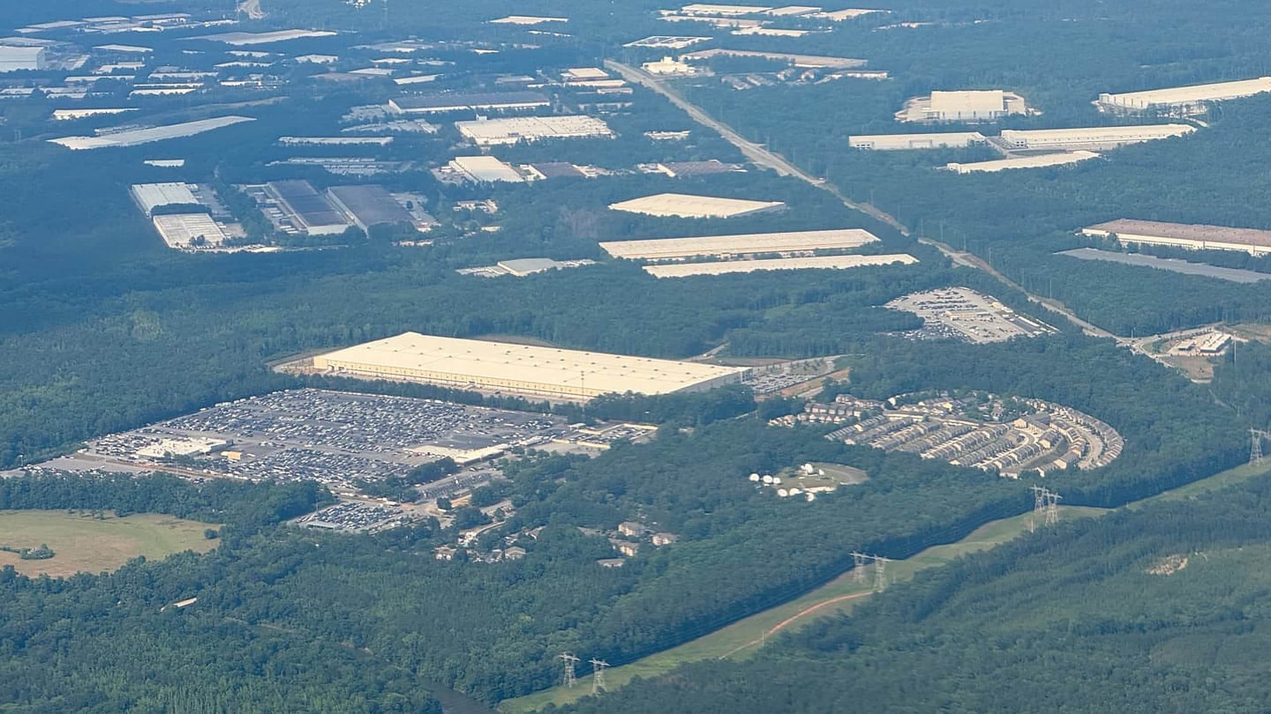 Aerial view of flat-roofed commercial warehouses with large unobstructed roof planes.
